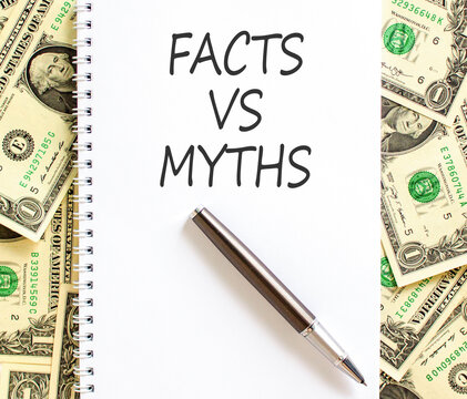 Facts vs versus myths words symbol. Concept words Facts vs Myths on beautiful white note. Beautiful dollar bills background. Business and facts vs versus myths concept. Copy space.