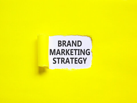 Brand marketing strategy words symbol. Concept words Brand marketing strategy on beautiful white paper. Beautiful yellow background. Business and brand marketing strategy concept. Copy space.