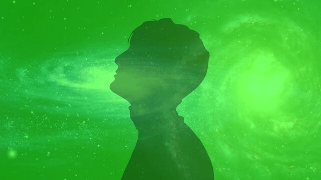 Glowing silhouette of meditating human figure sitting in lotus position over dynamic green mandala background