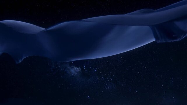 Blue translucent fabric ribbon flowing in slow motion over starfield space background 60fps