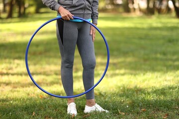 Senior woman with hula hoop outdoors, closeup. Space for text © New Africa