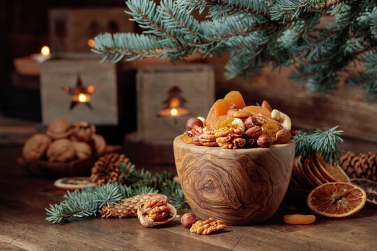 Dried fruits and assorted nuts on an old wooden table.