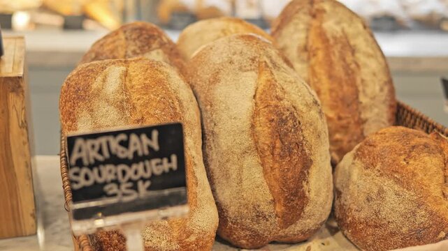 Rustic bakery display with artisan bread and golden crust display of fresh loaves on shelf Gourmet display creates warm bakery mood organic bread selection for food market and rustic interior charm