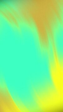 Vibrant abstract blurred background with smooth gradient transition of green and yellow tones.