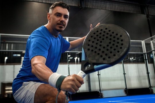 Padel tennis player. Open social tour template. Padel tennis player on the blue court background outdoors. Paddle tenis template for bookmaker design ads with copy space.