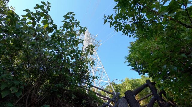 Looking Up at a Transmission Tower Against a Blue Sky