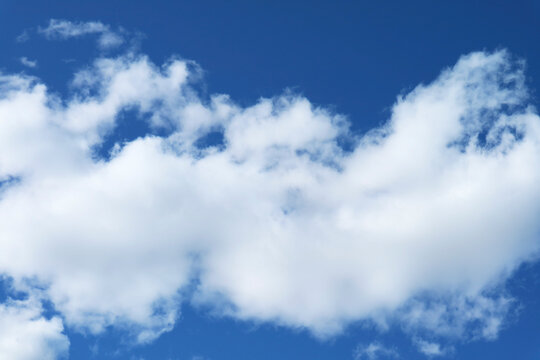 Pure White cumulus clouds flowing on vivid blue sky