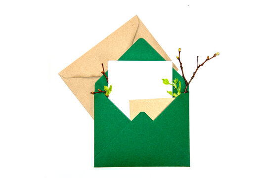 A vibrant green envelope holds a blank card surrounded by twigs and leaves, inviting personal notes and letters filled with love and warmth