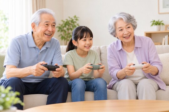 自宅でテレビゲームを楽しむ日本人の祖父母と孫娘