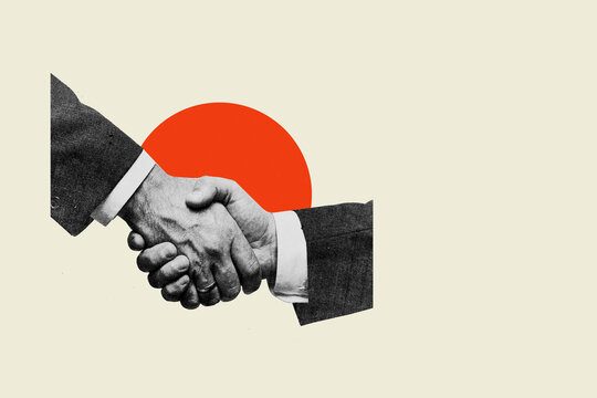 Businessmen shaking hands in corporate agreement against red circle background
