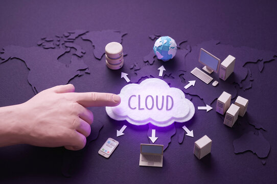 Hand pointing at a central CLOUD icon surrounded by global network devices and database on a world map background, 3d render
