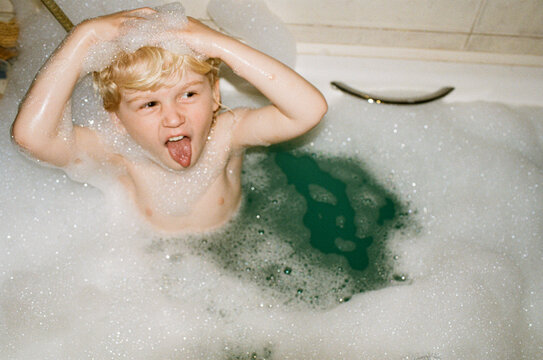 A little boy enjoys taking a bath