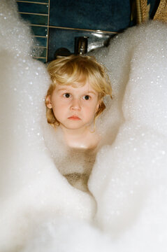 A little boy enjoys taking a bath