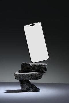 Smartphone mockup floating above stacked stones
