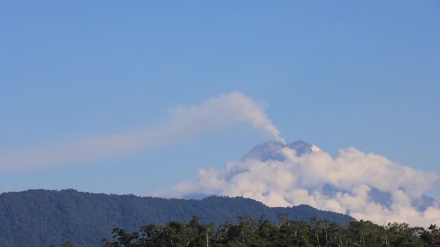 Wide Shot of Sangay Volcano Erupting While Being Covered by Clouds During Daytime from Macas, Ecuador