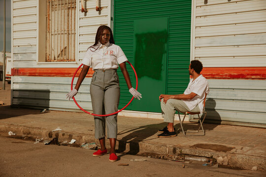 Portrait of a young woman with hula hoop.