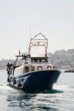 Commercial fishing boat returning through the harbor