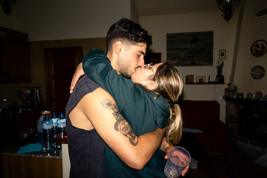 A tender kiss inside the family home