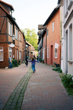 grandmother and grandkids exploring old town portion of German city