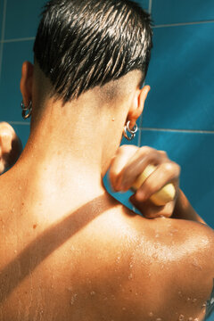 Person Taking a Shower with a Bar of Soap