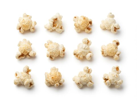 Top view of twelve individual pieces of crunchy popcorn arranged in a grid pattern isolated on white background