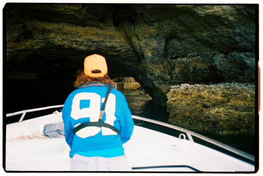 Back view Boat Entering Sea Cave