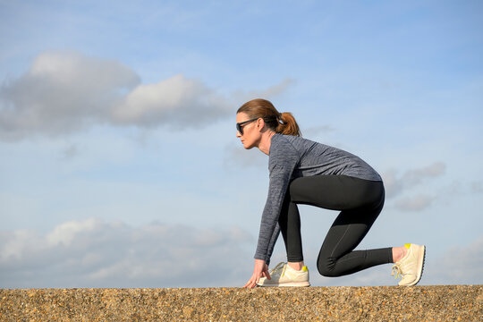 Woman in Athletic Wear Preparing for a Run