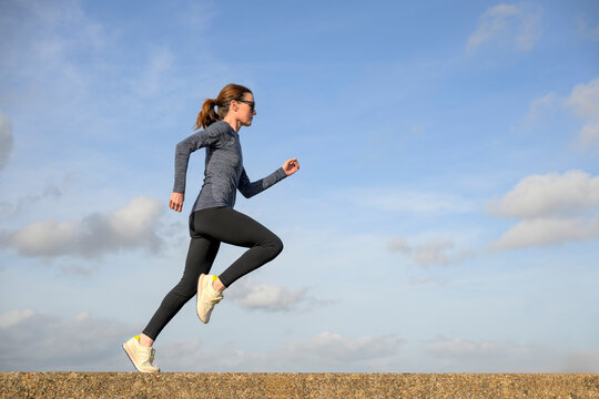 Woman Jogging Along a Coastal Path