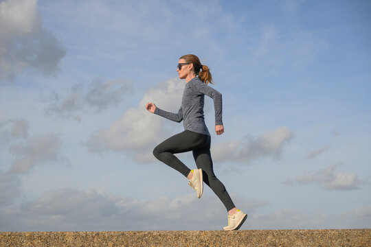 Woman Jogging Along a Coastal Path