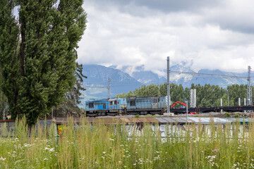 Freight Train Engine Moving Along Scenic Mountain Range © Jorens