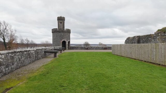 Low aerial flight across the lawn to the cannon-lined terrace and turreted tower of Shane's Castle on Lough Neagh, Northern Ireland