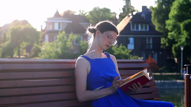 Young woman immersed in book reading. Digital detox by choice. Modern mindfulness practice outdoors on nature. Book lovers day