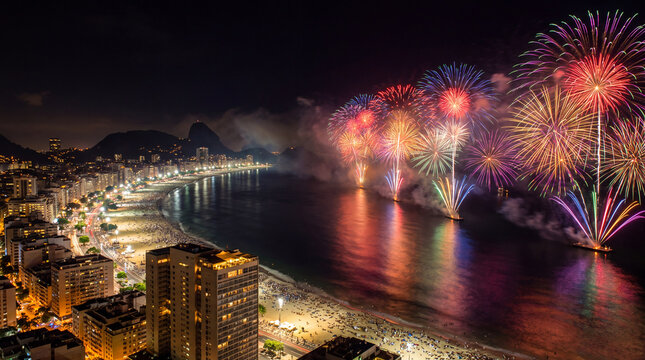 Breathtaking night view of vibrant fireworks bursting over the sea at Copacabana Beach in Rio de Janeiro during a New Year Eve celebration.