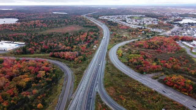 Autumn colors surround a busy highway and solar panels in nova scotia, canada