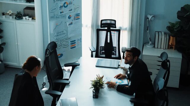 Business people sitting at seat and prepare for meeting at whiteboard with colorful sticky notes and mind map. Professional diverse group talking about marketing plan at meeting room. Directorate.