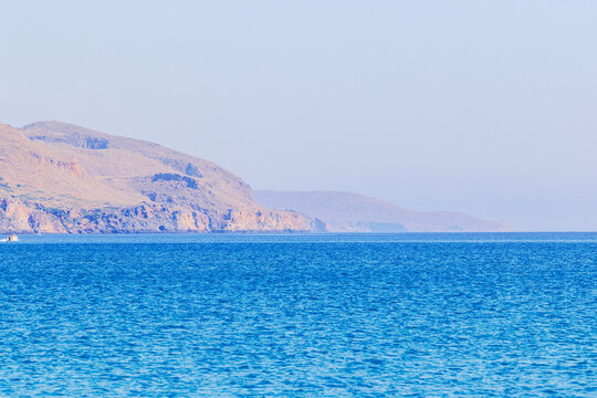 Beautiful view of Mediterranean Sea stretching toward rugged headlands fading into coastal haze. Greece. Crete.
