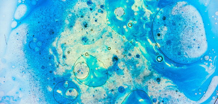 Blue liquid abstract background mixing colors and bubbles