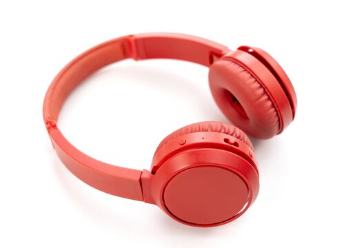 Modern wireless red headphones on white background studio shot
