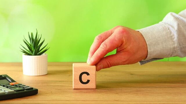 Businessman moves a wooden block with the symbol CBAM Carbon Border Adjustment Mechanism. A business environmental concept. The EU border carbon tax for imported goods. copy space