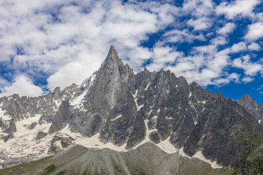 Impressive view of Les Drus, a dramatic pair of granite peaks in the Mont Blanc massif of the French Alps near Chamonix. The iconic mountain formation rises above deep alpine valleys