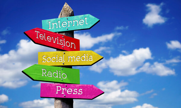 Internet, television, social media, radio, press - wooden signpost with five arrows, sky with clouds