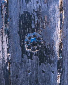 Metal artefact on a wooden surface.