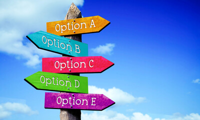 Option A, B, C, D, E - wooden signpost with five arrows, sky with clouds © PX Media