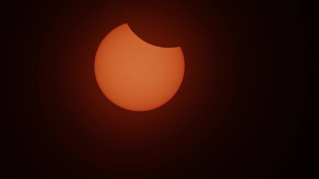 A partial solar eclipse glows over Nova Scotia in 2026, as the moon slowly moves across the face of the sun