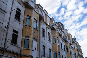 Low Angle View of Multi-Story Urban Building Facade with Cloudy Sky © MarshallChan