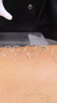 Professional body shaping therapy with vibromassage thermo vacuum and bioelectrical stimulation in beauty salon - vertical video