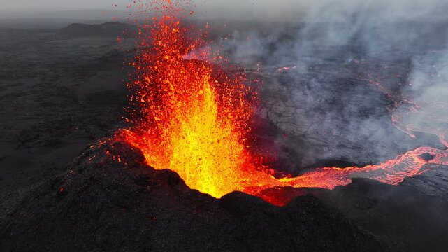 Active Volcanic Crater Erupting Molten Lava Fountain with Smoke and Ash Cloud Field