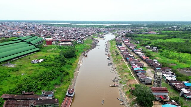 Panoramic aerial view of the traditional riverside district of Belen in Iquitos, showing characteristic stilt houses (palafitos) along the banks of the Itaya River in the Peruvian Amazon.