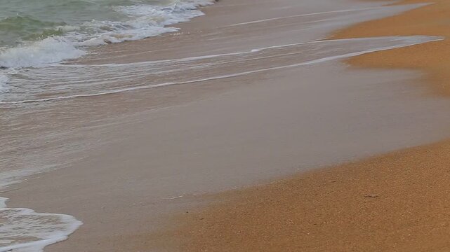 Ocean waves washing a sandy beach in Sri Lanka