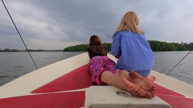 Two girls riding a boat in Sri Lanka